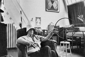  Duchamp wearing a lampshade with Bicycle Wheel